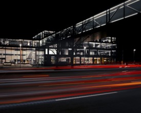 View across a street to the main entrance of the Continental administration building at night,