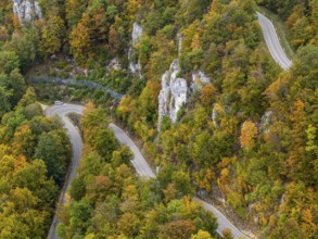 Swabian Alb in autumn, Albtrauf with colourful mixed forest and winding country road. Bad Urach,