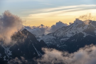 Mountain landscape at sunset, clouds around mountain peaks, Chamonix, Haute-Savoie, France, Europe
