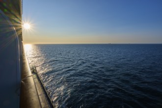 View from cruise ship, Mein Schiff 6, onto the wide sea at sunrise, under a clear blue sky, autumn,