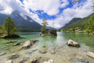 Hintersee near Ramsau with clear green water, surrounded by forests and mountains under a cloudy