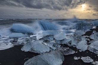 Ice floes on the beach, waves, sea, clouds, sunlight, winter, Diamond Beach, Breidamerkursandur,