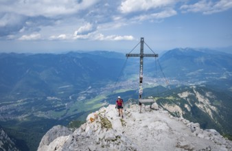 Hiker on the summit of the Alpspitze, Wetterstein range, Bavaria, Germany, Europe
