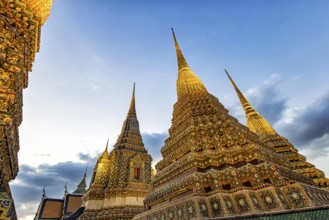 Wat Pho temple at sunset. Bangkok's oldest Buddhist monastery near the Grand Palace. Four chedis