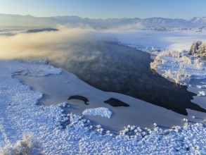 Aerial view of a lake in front of mountains, winter, snow, morning light, fog, Riegsee, Alpine