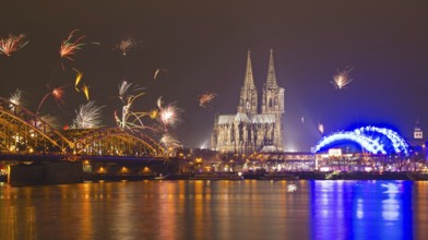New Year's Eve fireworks, Hohenzollernbruecke with cathedral and Musical Dome, Rheinufer, Cologne,
