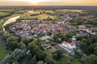 Aerial view of village Lenzen and river Loecknitz (Löcknitz) at sunset, Brandenburg, Germany,