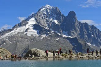 At the Lac Blanc mountain lake, with the Aiguille Verte and Aiguille du Dru peaks behind, Chamonix,