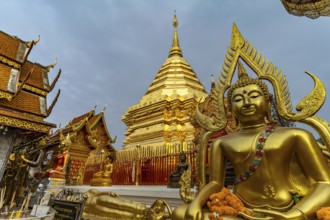 Buddha statue and Golden Chedi of the Buddhist temple complex Wat Phra That Doi Suthep, landmark of