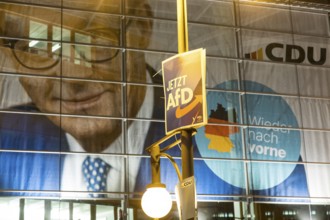 Banner with the likeness of Friedrich Merz behind an AfD election poster (now AfD) at the