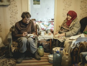Varvara, 85, and her son Leonid, 56. Leonid looks after his mother, who is in need of care. She
