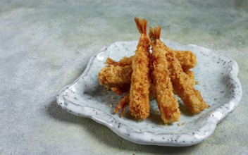 Fried shrimp, peeled in tempura, soy sauce, close-up