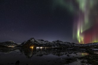 Northern lights over fjord, steep mountains, winter, aurora borealis, Flakstadoya, Lofoten, Norway,
