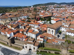 Aerial view of a city with red tiled roofs and old walls on a sunny day, aerial view, Puerta de