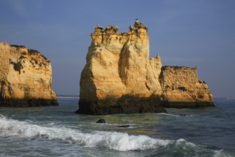 Praia do Pinhao, Lagos, Algarve, Portugal, Impressive rock formations rise out of the blue sea,