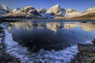 Sunrise, morning light, steep mountains and fjord, ice, winter, Flakstadoya, Lofoten, Norway,