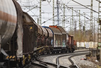 Goods train travelling on the winding Schuster Railway, overhead lines and infrastructure.