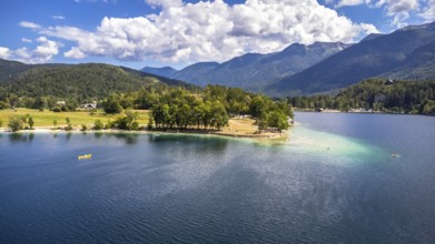 Aerial view of tourists enjoying summer holidays, swimming and kayaking on the beautiful lake