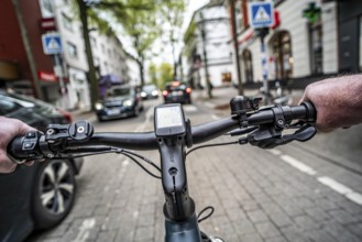 Cycling in the city, inner-city street, cycle lane, bicycles have priority, two-lane traffic with
