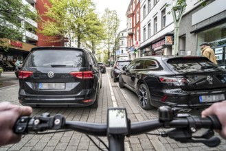 Cycling in the city, inner-city street, cycle lane, bicycles have priority, two-lane traffic with