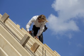 Carpenters working on the roof of a new building in the Rhein-Pfalz district