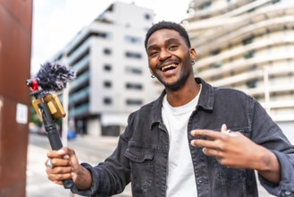Handsome young african male influencer vlogging while walking along the city
