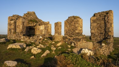 The ruins of Kenidjack Cliff Castle in the evening. Golden hour. Good weather, blue sky. Penzance,