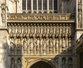 Carved stonework frieze above entrance door, Westminster abbey church, Westminster, London,