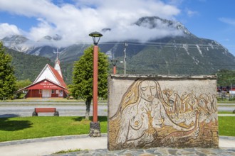 Relief of an indigenous woman and church in the village of Chaiten, Pumalin-Douglas Tompkins