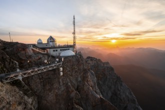 Mountain station of the Tyrolean Zugspitze railway at the summit of the Zugspitze, at sunset,