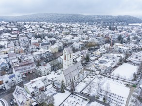 Snowy village landscape with church and surrounding buildings in a wintry setting, Aidlingen,