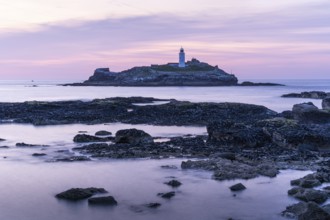 Godrevy Lighthouse, the lighthouse of Godrevy on Godrevy Island. In the evening at sunset. Long