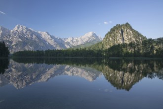 Lake Almsee in summer with totally smooth surface showing reflexion of the mountain Ameisstein