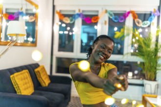 Portrait with copy space of a cool african woman dancing during night home party