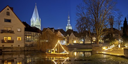 Large pond, St. Patrokli Cathedral and St. Peter's Church in the evening during winter sunshine,