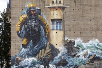 Astronaut standing in surf, mural on the subject of climate change on a bunker, by street art