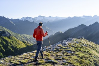 Hiker enjoying the mountain panorama in the morning, Venediger group, behind Dreiherrenkopf,