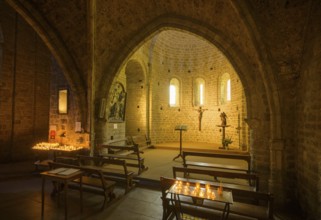 Side chapel with burning candles in the Abbey of Gellone, also Saint-Guilhem-le-Désert Monastery,