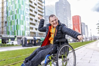 Portrait of a cheerful disabled young man enjoying a day out in the city, celebrating his mobility