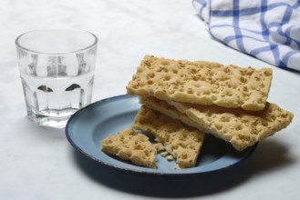 Crispbread on a plate and glass of water
