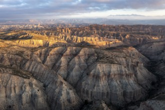 Sunrise, wide hilly desert landscape with dry vegetation, Gorafe desert, semi-desert, Granada,