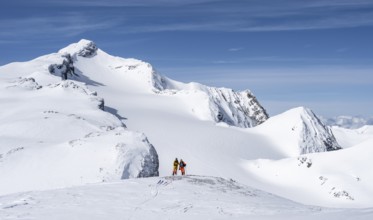 Two ski tourers in front of a snow-covered mountain landscape, Wildhorn in winter, Bernese Alps,