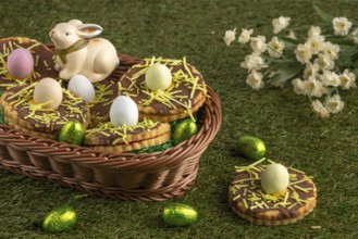 Easter biscuits in the shape of a nest with eggs in a basket in a meadow