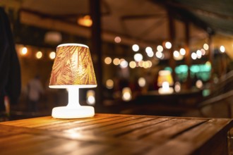 Soft, warm lighting creates a cozy atmosphere at a rustic wedding venue, highlighting elegant