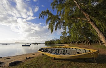 Yellow fishing boat on the beach at Calodyne, Gunner's Coin island in the background, Riviere du
