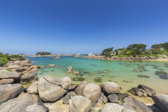 Beach with rocks and sand at the Plage Saint Guirec, with clear blue sky and colors as in the