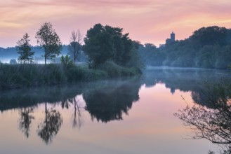 Sunrise at the Saale river with ruins of Schönburg castle, water reflection, morning fog, Naumburg,