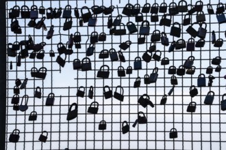 Padlocks, so-called love locks on a fence, vantage point in Wesel am Rhein, North Rhine-Westphalia,
