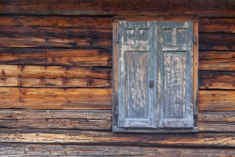 Detailed view of wooden shutters of a hut on an alpine meadow at the foot of the Peitlerkofel,