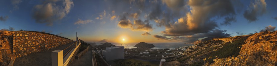 360° panoramic image of an enchanting sunset over the coastal landscape with the town of Arkasa,